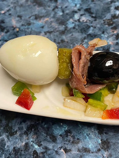 Una foto de Pincho de anchoa, huevo de codorniz y encurtidos con vinagreta de pimientos