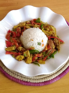 A picture of White rice and chicken chunks sauce.