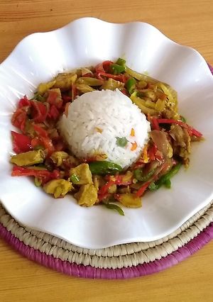 A picture of White rice and chicken chunks sauce.