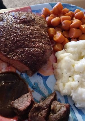 A picture of Seasoned Swiss Steak w/ Glazed Carrots and Ranch Mashed Potatoes.
