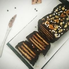 A picture of Chocolate Biscuit Cake with Sugar coated Coconut Biscuits.