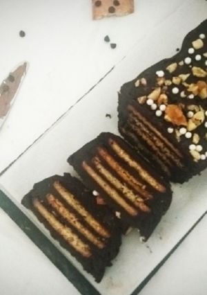 A picture of Chocolate Biscuit Cake with Sugar coated Coconut Biscuits.