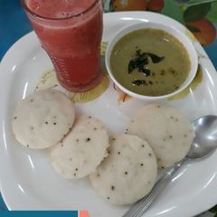 A picture of Idli, Green Coconut Chutney with refreshing Watermelon Juice.