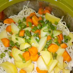 A picture of Spaghetti with veggies and stew.