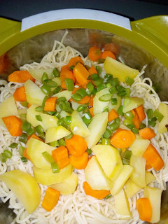 A picture of Spaghetti with veggies and stew.