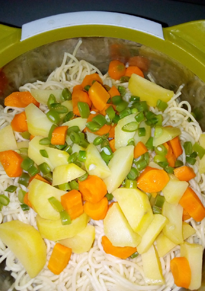 A picture of Spaghetti with veggies and stew.