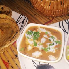 A picture of Dal makhani with masala lachha parantha.
