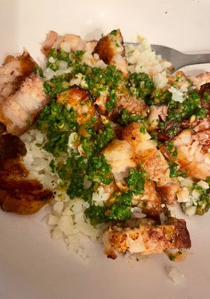 A picture of Pork Belly With Cauliflower Rice & Coriander Chutney.