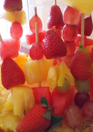 A picture of Edible fruit arrangement on a pineapple boat.
