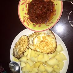 A picture of Cooked potato, omelette & sauce🍳🌶🥔.