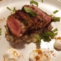 A picture of Duck breast with Indian spice rub on cauliflower coconut puree.