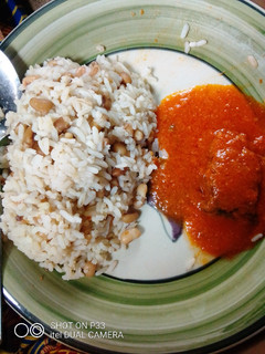 A picture of Rice🍚 and beans with fish soup.