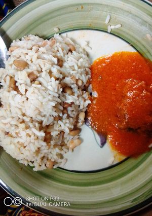 A picture of Rice🍚 and beans with fish soup.