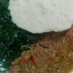 A picture of Minced meat with kales and ugali.
