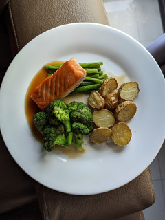 A picture of Pan Fried Salmon with Vegetables and Roasted Potatoes.