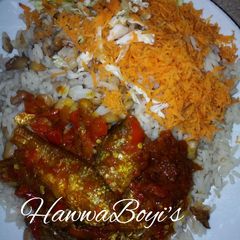 A picture of Rice and beans with Stew and fish.