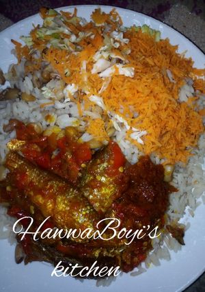 A picture of Rice and beans with Stew and fish.