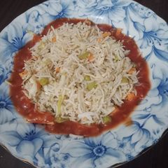 A picture of Chili Garlic sauce with Fried Rice.