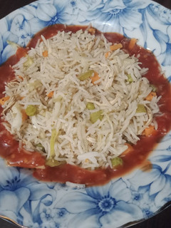 A picture of Chili Garlic sauce with Fried Rice.