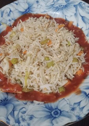 A picture of Chili Garlic sauce with Fried Rice.