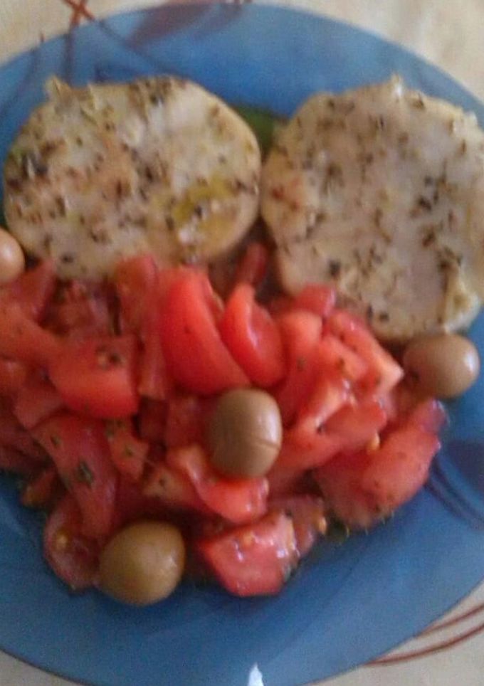 Una foto de Rodajas de merluza, con ensalada de tomate