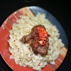 A picture of Plain bow tie pasta with chicken sauce.