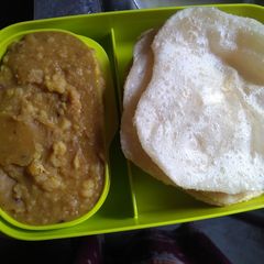 A picture of Puri and chana daal.
