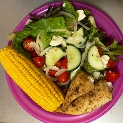 A picture of Green salad, sweet corn and baked hake.