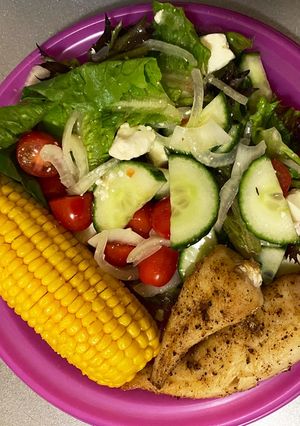 A picture of Green salad, sweet corn and baked hake.
