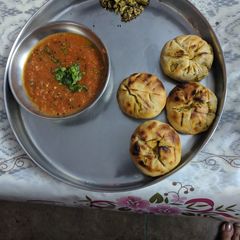 A picture of Bharwan Baati with Tomato dip(chutney).