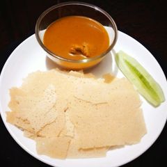 A picture of Chicken curry with kori rotti.