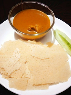 A picture of Chicken curry with kori rotti.
