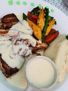 A picture of Grilled Fish (salmon) with mashed potato.