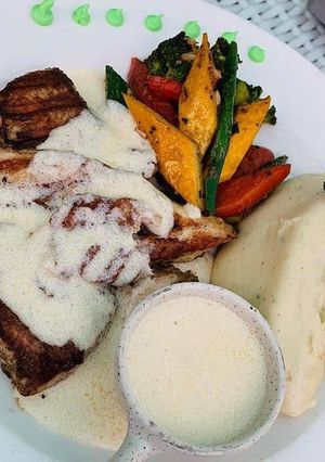 A picture of Grilled Fish (salmon) with mashed potato.