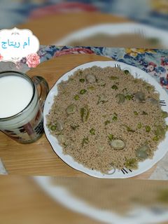 صورة لوصفة كسكس القمح الكامل بالفول والجلبانة 🥛