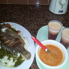 Ugali, Kales, Fried Fish, and Carrot chatni A picture of Ugali, Kales, Fried Fish, and Carrot chatni.
