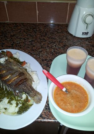 A picture of Ugali, Kales, Fried Fish, and Carrot chatni.