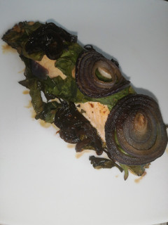 Una foto de Salmón con espinacas y cebolla morada