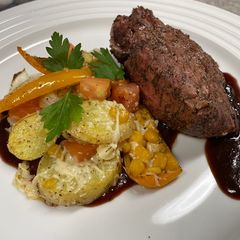 A picture of Grilled Filet & Parmesan Potato Medallions.