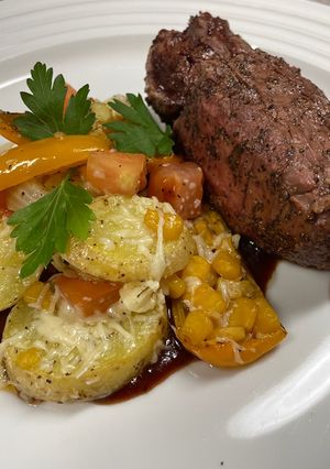 A picture of Grilled Filet & Parmesan Potato Medallions.
