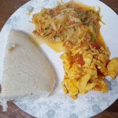 A picture of Cabbage ugali and eggs.