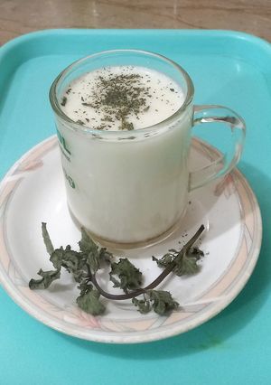 A picture of Lassi with honey and mint.