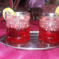 A picture of Roohafza with sabza and lemon.