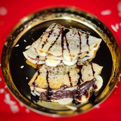 A picture of Dosa with Chocolatey Nutella and ripe banana filling.