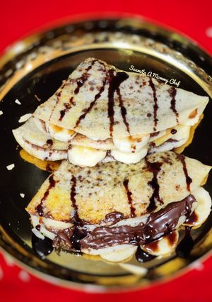 A picture of Dosa with Chocolatey Nutella and ripe banana filling.