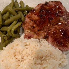A picture of Grilled Pork Chop with a Raspberry Chipotle Sauce.