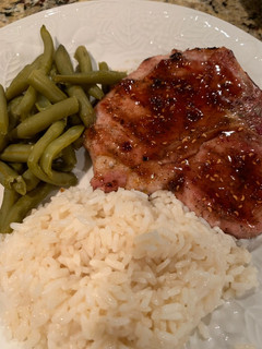 A picture of Grilled Pork Chop with a Raspberry Chipotle Sauce.