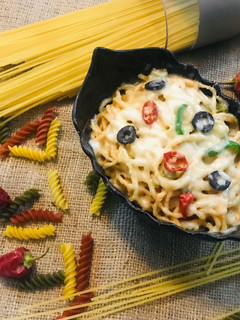 A picture of Spaghetti with cheese and pepper.
