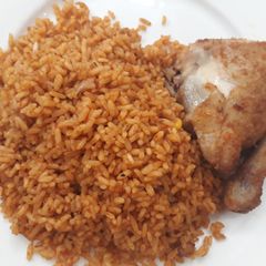 A picture of Jollof rice and fried chicken.