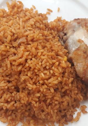 A picture of Jollof rice and fried chicken.